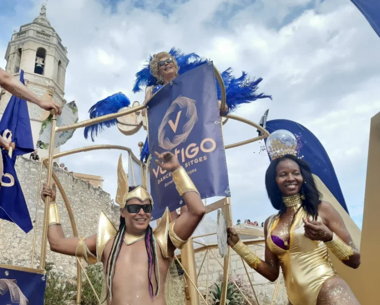 Pride-Parade mit der LGTBIQ+-Flagge bei der Sitges Pride Parade, mit Publikum auf den Straßen
